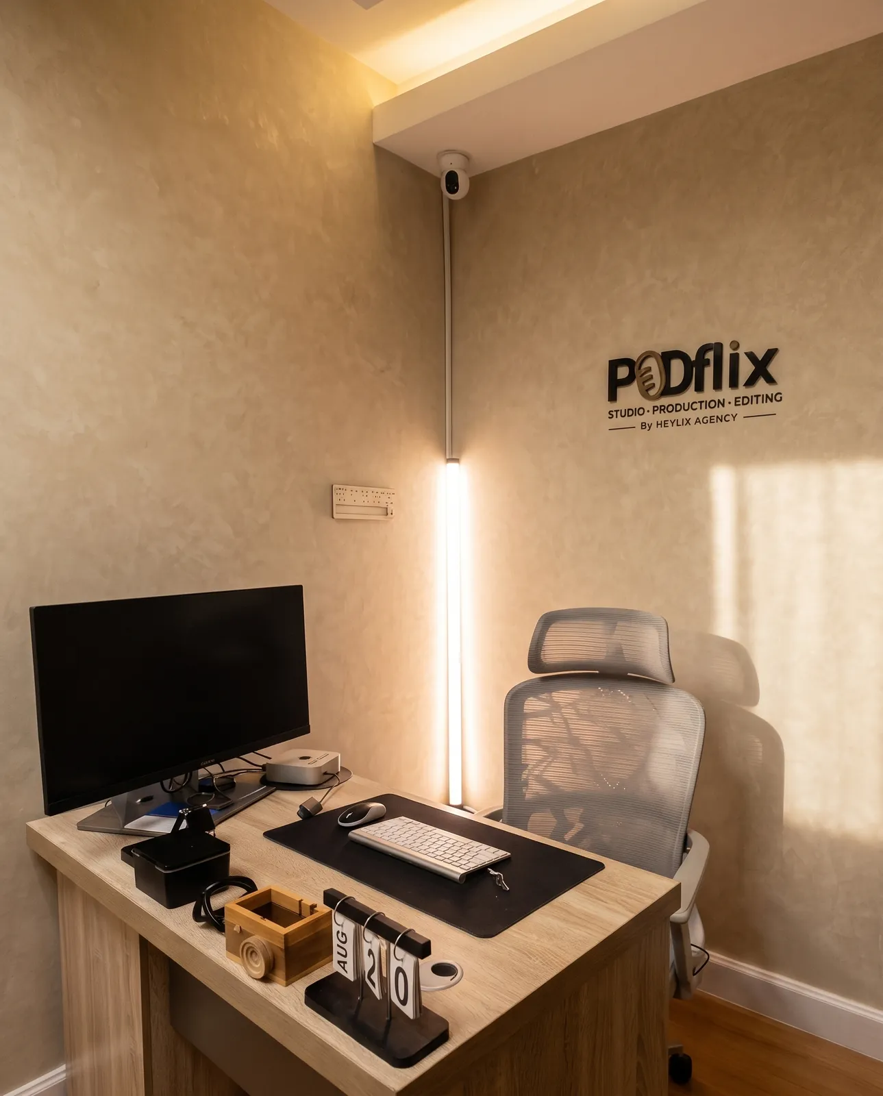 The Podflix production and editing room, editing desk beneath the studio signage — Business Bay Dubai